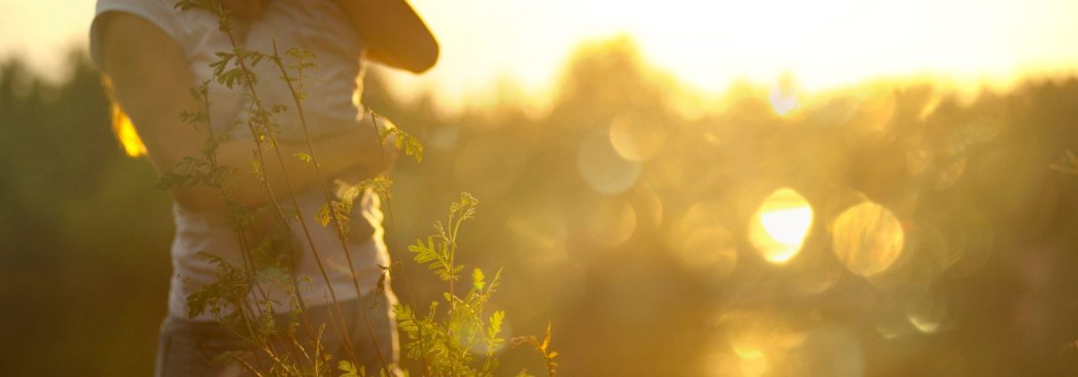 Self care ideas for mums: A mum carries her infant in the setting sun