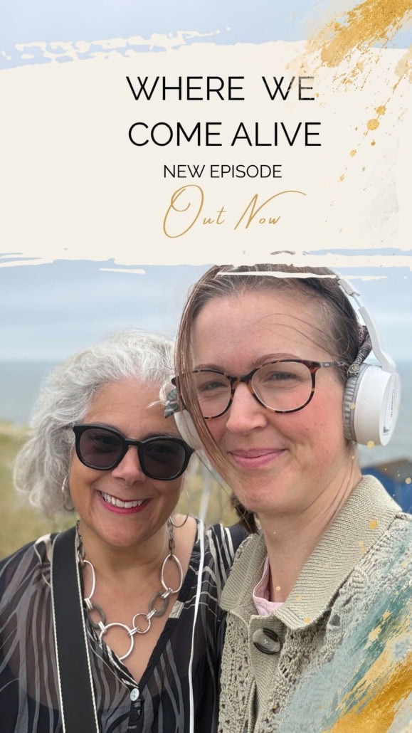 Two women smiling outdoors, one with headphones, in a scenic natural setting.